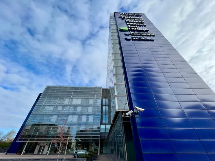 The Ilmarinen building in Helsinki, home of Team Finland, Business Finland and Finnvera, under a cloudy blue sky